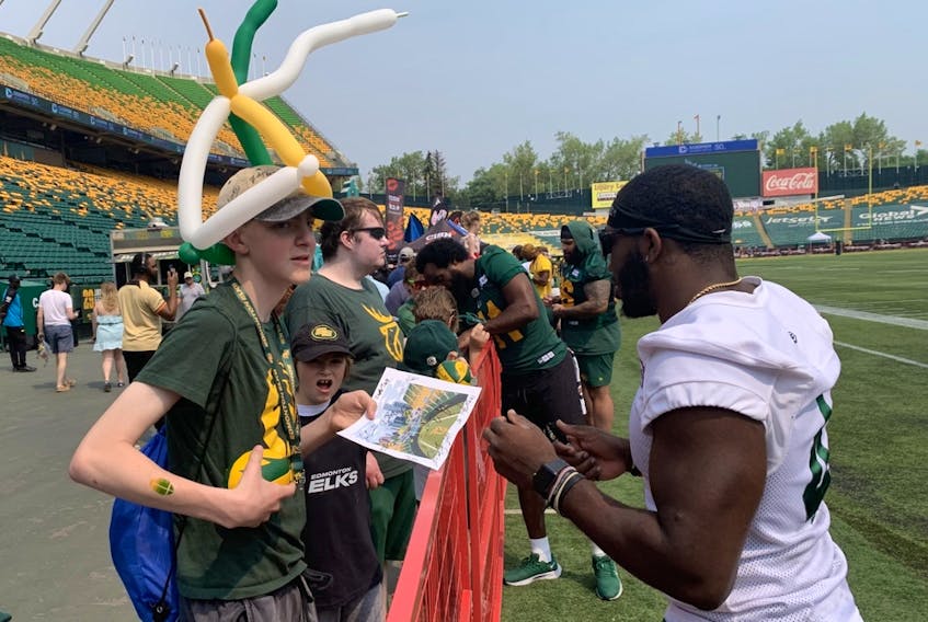 Edmonton Elks running back Kevin Brown signs autographs during Fan Appreciation Day at Commonwealth Stadium on Saturday, June 10, 2023.