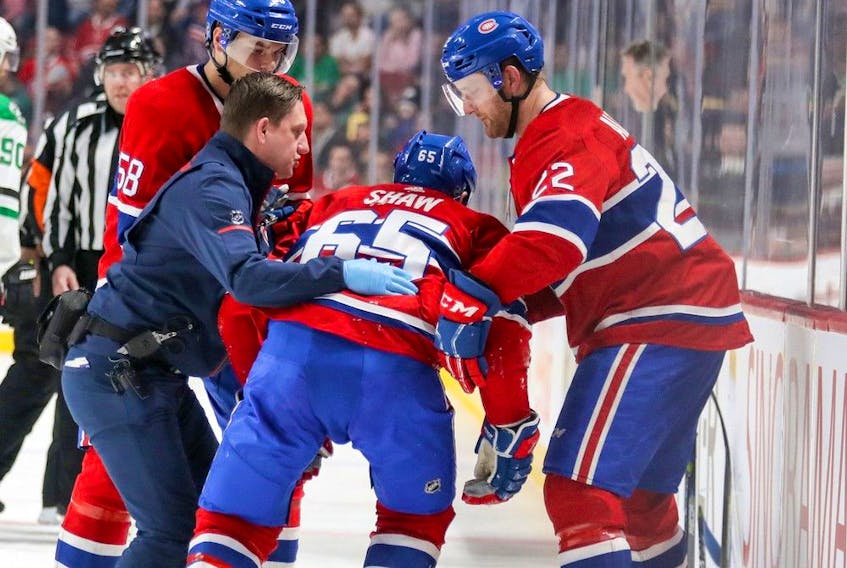 Graham Rynbend, the Canadiens’ chief athletic therapist, helps Andrew Shaw off the ice after he was injured during a game at the Bell Centre on March 13, 2018.