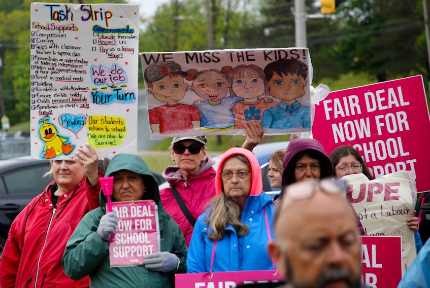 Striking CUPE school support workers listen to a speaker during a news conference at the picket line at the corner of Woodlawn Road and Main Street in Dartmouth last week. A tentative deal was announced Wednesday.