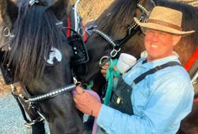 Jim Lester and his two Percheron horses he got as a gift for his 40th birthday.