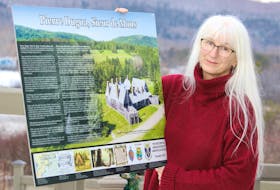 Christine Igot, chairperson of the Annapolis Royal twinning committee, displays a new interpretive panel on Pierre Dugua, Sieur de Mons, which will be unveiled during a ceremony in Annapolis Royal on June 18. File
