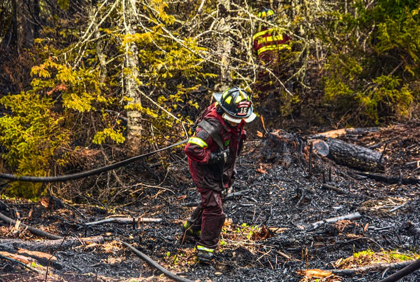 Volunteer firefighters aided in the battle against the Barrington Lake wildfire, which broke out in late May. FRANKIE CROWELL PHOTO