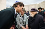 Prime Minister Justin Trudeau greets cantor Moshe Kraus, right, and his wife, Rivka, at a remembrance ceremony at the National Holocaust Monument in Ottawain April.
