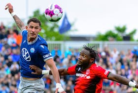 HFX Wanderers' Tiago Coimbra heads the ball while being defended by Cavalry FC's Bradley Kamdem during Canadian Premier League action Saturday afternoon at the Wanderers Grounds. - Trevor MacMillan / HFX Wanderers