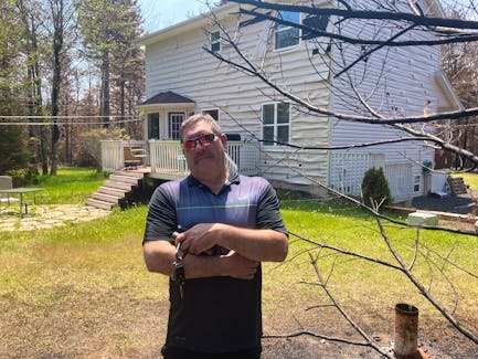 Ed Duval stands in front of his Hammonds Plains home. He says the wildfires caused at least $40,000 in damage to his property.