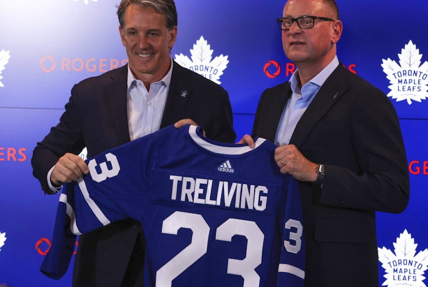 Toronto Maple Leafs president Brendan Shanahan (left) and Brad Treliving hold up a team jersey.