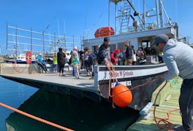 The stern line is untied from the Pickin N Grinnin as the vessel readies to depart  from the Falls Point wharf in Woods Harbour for an end of the season trip to the lobster fishing grounds with a special crew aboard. KATHY JOHNSON