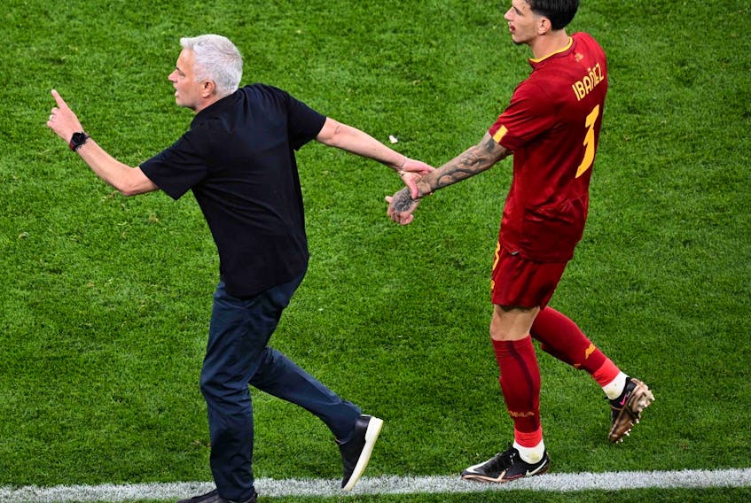 AS Roma's Portuguese coach Jose Mourinho (L) reacts to the injury of AS Roma's Brazilian defender Roger Ibanez during the UEFA Europa League final football match between Sevilla FC and AS Roma at the Puskas Arena in Budapest on May 31, 2023. 