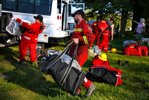 Volunteer firefighters  grab their kits at the Shelburne Fire Hall on Thursday, June 1, 2023 and head to trucks en route to battle the Barrington wildfire. TIM KROCHAK PHOTO