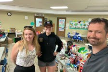 Jackie Best, left, and Mariah Getson, volunteer firefighters with the Victoria Village Volunteer Fire Department in P.E.I., are volunteering at the Full Gospel Church in Bedford, N.S., which is handling donations for people that have been affected by the Halifax wildfires. With them is Pastor Kurt Arnold who is originally from Charlottetown. Contributed