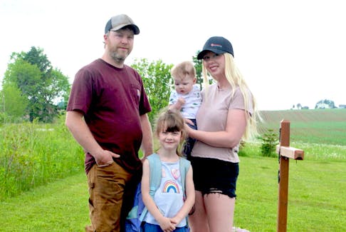 Dylan Bourgeois, left, daughter, Everly, centre, and wife, Olivia, told SaltWire they are scared after reporting three incidents of vehicles speeding past Everly's school bus while the red lights on the back were still flashing.