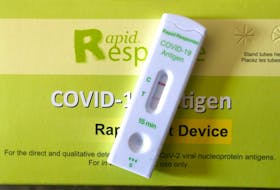 A positive result for an at home COVID-19 rapid test is shown near Calgary on Friday, January 14, 2022. the province says the end of the rapid test program represents a shift to PCR testing — tests that produce results confirmed in a lab and take longer.