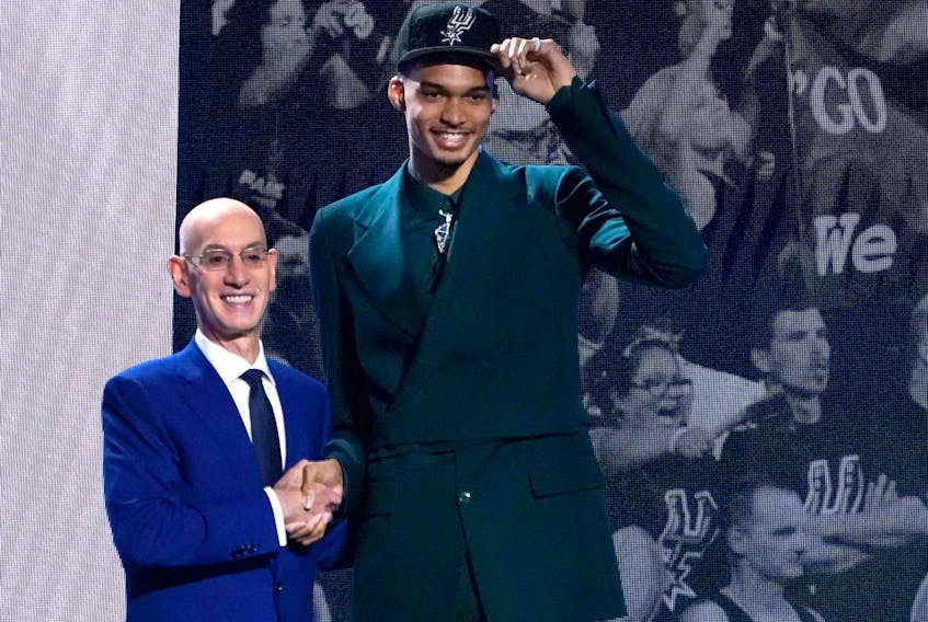 French basketball player Victor Wembanyama (R) shakes hands with NBA commissioner Adam Silver after being picked by the San Antonio Spurs during the NBA Draft at Barclays Center in New York city, on June 22, 2023.