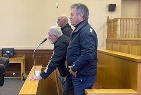 Vincent Leonard Sr., James Curran and Wayne Johnson stand in Newfoundland and Labrador Supreme Court in St. John's as Justice Daniel Boone enters to deliver his decision Thursday, May 4, 2023