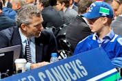  Elias Pettersson talks with Vancouver Canucks executives after being selected fifth overall during the 2017 NHL Draft at the United Center on June 24, 2017 in Chicago, Illinois.