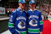  Elias Pettersson, left, and Kole Lind pose for photos after being drafted by the Vancouver Canucks during the 2017 NHL Draft at the United Center on June 24, 2017 in Chicago, Illinois.