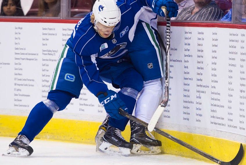  Kristoffer Gunnarsson ( L ) and Jakob Stukel ( R ) battle along the boards in the Canucks Summer Showdown Top Prospect game at Rogers Arena Vancouver, July 06 2017.