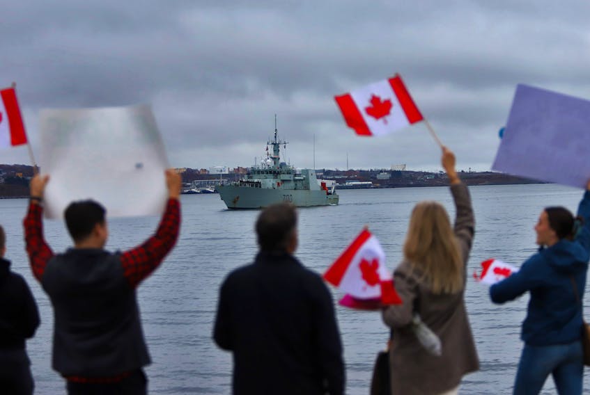 Family members and friends wave flags and signs at HMC Dockyards in Halifax Tuesday, Nov. 1, 2022, as  His Majesty’s Canadian Ships (HMCS) Kingston (pictured) and Summerside (out of frame) return to HMC Dockyard after successfully completing their deployments in support of NATO assurance and deterrence measures in European waters. SaltWire file

TIM KROCHAK PHOTO