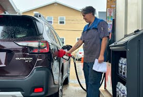 Brittany Shea, a Brookvale resident, pumps gas at the Ken's Corner Petro-Canada in Charlottetown June 28. The prices of gas and other fuels are going up July 1 when federal carbon price changes go into effect in P.E.I. Thinh Nguyen • The Guardian