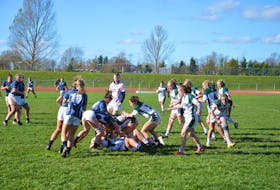 The UPEI Panthers, white jerseys, and St. Francis Xavier X-Women battle it out at MacAdam Field in Charlottetown in an Atlantic University Sport (AUS) women’s rugby game in October 2022. UPEI will host the 2024 U Sports women’s rugby championship. File