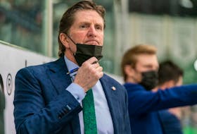 University of Saskatchewan Huskies head coach Mike Babcock looks onto the rink during the first period of U Sports Canada West men's hockey playoff action at Merlis Belsher Place in Saskatoon, Sask. on Friday, February 25, 2022.