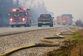 Hose lies along Highway 103 while fire crews work on wildfire flareups in Shelburne County on Friday, June 2. COMMUNICATIONS NOVA SCOTIA