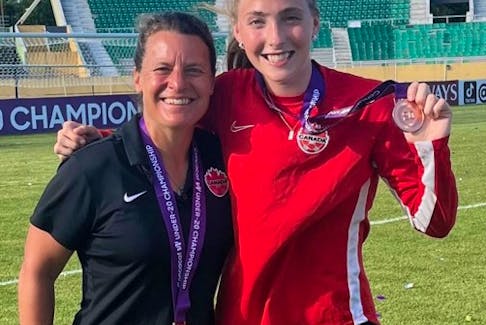 Head coach Cindy Tye of Bedford and Mya Archibald of Fall River display their bronze medals at the Concacaf Women’s Under-20 Championship in Santo Domingo, Dominican Republic, on Sunday.