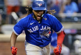  Vladimir Guerrero Jr. of the Toronto Blue Jays reacts after hitting an RBI double during the ninth inning against the New York Mets at Citi Field on Saturday. 
