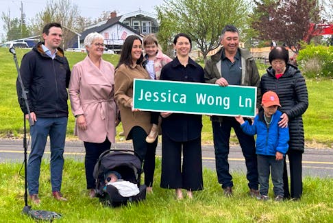 From left, Mitchell Brewer, Wendy Wong (mother), baby Max, Samantha Wong (holding niece Sophia MacDonald), Jessica Wong, Alex Wong (Jessica's father), Breton Currie (cousin) and grandmother Violet Wong attend a street renaming in honour of Jessica Wong in Baddeck on Monday. IAN NATHANSON/CAPE BRETON POST