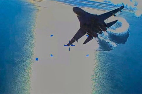 FILE PHOTO: A Russian Su-27 military aircraft dumps fuel while flying by a U.S. Air Force MQ-9 "Reaper" drone over the Black Sea, March 14, 2023 in this still image taken from handout video released by the Pentagon. Courtesy of U.S. European Command/The Pentagon/Handout via REUTERS  A Russian Su-27 military aircraft dumps fuel while flying by a U.S. Air Force MQ-9 "Reaper" drone over the Black Sea, March 14, 2023 in this still image taken from handout video released by the Pentagon. Courtesy of U.S. European Command.