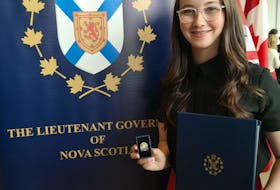 Emily Morneau, a Grade 12 student at Centre Scholaire Étoile de l'Acadie in Sydney, holds the Lieutenant Governor's Respectful Citizenship Award after receiving it at a ceremony earlier this month. CONTRIBUTED