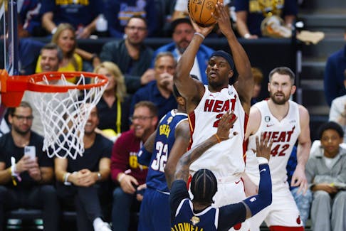 Jimmy Butlerof the Miami Heat shoots over Kentavious Caldwell-Pope of the Denver Nuggets during the NBA Finals.