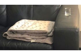 In the days after allegedly sexually abusing his client during a therapy session in June 2020, psychologist Dr. André Dessaulles repeatedly emailed and texted her in an attempt to get her back into therapy. He texted this picture of his office couch, with his client's therapy blanket beside an empty shot glass. "Would be so great if you were here," he said in his text.