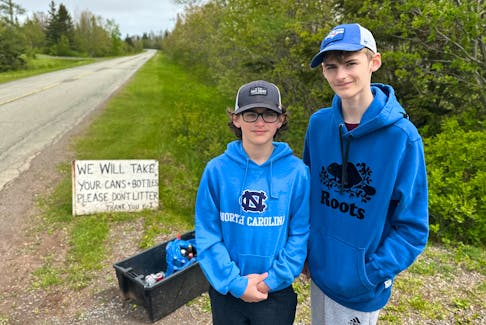 Jesse and Eli Anderson bring out their bin and sign every day and place them by the side of Macadam Road for people passing by to drop off recyclables like cans and bottles. Thinh Nguyen • The Guardian