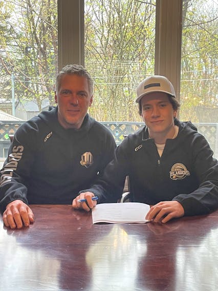 Charlottetown Islanders general manager and head coach Jim Hulton, left, joins centre Matthew Butler as he signs with the Quebec Major Junior Hockey League team for the 2023-24 season. The Islanders drafted Butler, who is from St. John’s, in the fifth round of the league's 2022 entry draft. Contributed
