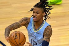 Ja Morant of the Memphis Grizzlies passes the ball against the Minnesota Timberwolves.