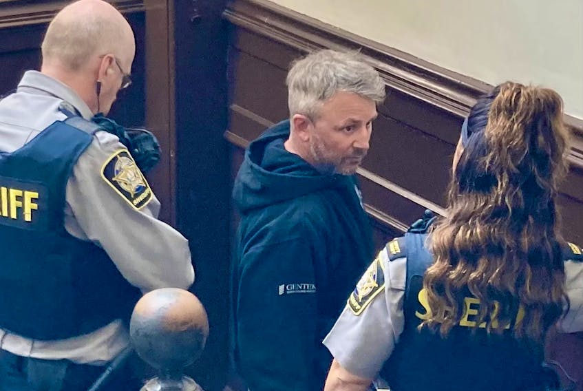 Shane Jason Mahar, 49, of Trenton is escorted into Halifax provincial court Wednesday for an appearance on five charges, including two counts of trafficking a person under the age of 18. Mahar will return to court Friday for a bail hearing.