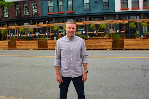 Kerry Lynch poses for a photo outside of his Brewery Park hotel on Agricola Street on Wednesday.