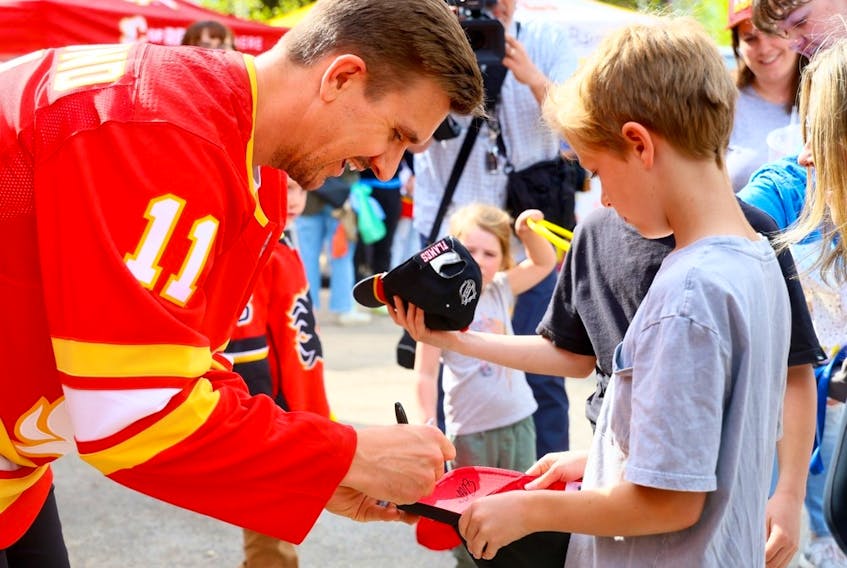 Mikael Backlund signs autographs as the Calgary Flames Foundation announced a significant donation to five recreational spaces in Calgary in partnership with the Parks Foundation Calgary on Thursday, May 11, 2023.