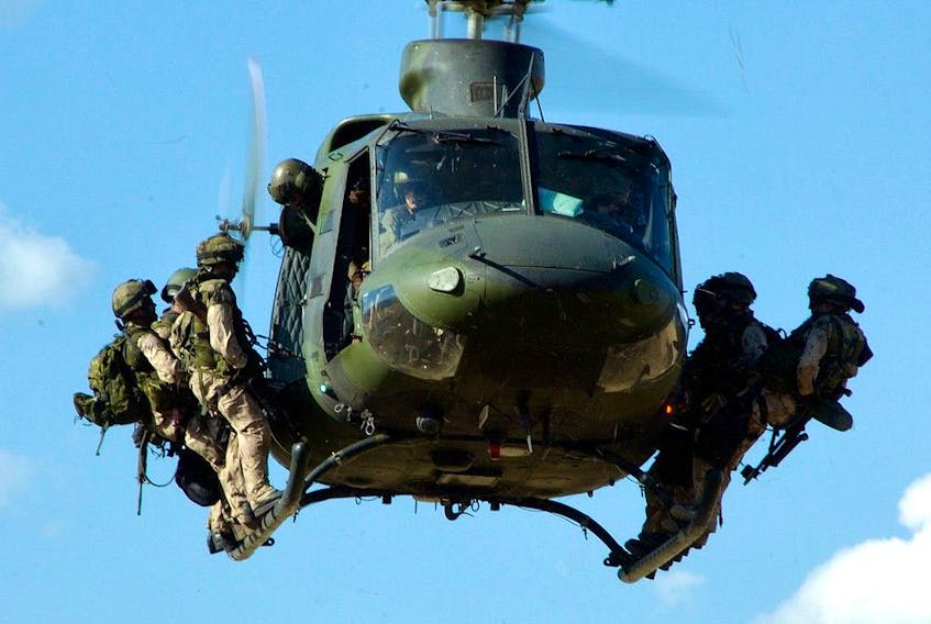 A file photo shows troops from the Canadian Special Operations Regiment (CSOR) preparing to rappel from a CH-146 Griffon helicopter from 427 Special Operations Aviation Squadron during a training exercise. 