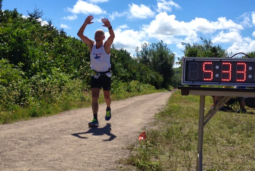 Peter (The Godfather) Hanna, with arms raised, during The Lou race in Inverness in 2013. The local running legend competed in more than 50 marathons in his life, as well as multiple Iron Man events, triathlons and ultramarathons — which are usually 50 kilometres or longer. CONTRIBUTED/CAPE BRETON ROAD RUNNERS