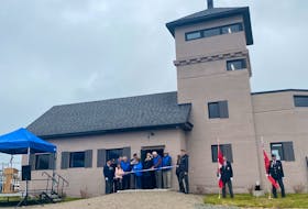 Atlantic Memorial Park board member Cyril Aker and the family of recently deceased board member Brian Ferguson cut the ribbon at the unveiling ceremony for the Chapel Point Battery in Sydney Mines on Tuesday. EMILY CONOHAN/CAPE BRETON POST