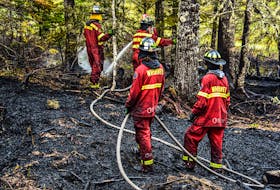 Dousing hotspots still a major part of the effort as the fight against the Barrington Lake wildfire continues. FRANKIE CROWELL PHOTO
