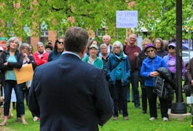 Premier Dennis King attended a rally on June 8 organized by the Coalition for the Protection of P.E.I. Lands, in which attendees vocally criticized his government's enforcement of the Lands Protection Act, as well as its actions in allowing a shorefront development to proceed at Point DeRoche. The rally was held outside the Coles Building in Charlottetown. Stu Neatby • The Guardian