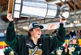 Saint-Hyacinthe Gaulois centre Caleb Desnoyers raises the Quebec under-18 hockey league championship trophy earlier this year. - Hockey Canada