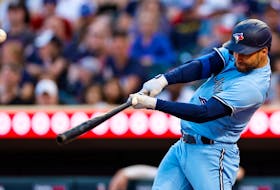Blue Jays' Kevin Kiermaier hits a triple against the Minnesota Twins in the fifth inning at Target Field on May 26, 2023 in Minneapolis.