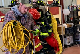 Woods Harbour Shag Harbour volunteer firefighter Brady Shand coils up an extension cord at the fire hall as he and other members of the department make sure their gear and trucks are ready to roll. KATHY JOHNSON