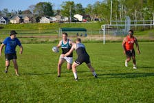 Ryan Lloyd defends against ball-carrier Jeremie Boutilier during a recent practice for the Charlottetown Rugby Football Club at Co-op Field in Charlottetown. Also attacking on the play are Osian Nicholas, left, and Christian Tasi, right. Jason Simmonds • The Guardian