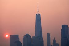 The One World Trade Center tower in lower Manhattan in New York City is pictured shortly after sunrise as haze and smoke caused by wildfires in Canada hangs over the Manhattan skyline in as seen from Jersey City, New Jersey, U.S., June 8, 2023. REUTERS/Mike Segar  The One World Trade Center tower in lower Manhattan in New York City shortly after sunrise as haze and smoke caused by wildfires in Canada hangs over the Manhattan skyline on June 8, 2023.