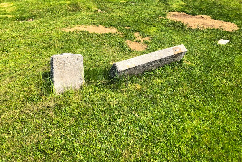 Monuments at a cemetery in Lower River Inhabitants with the crosses removed. Police are investigating the theft of the crosses. - Contributed